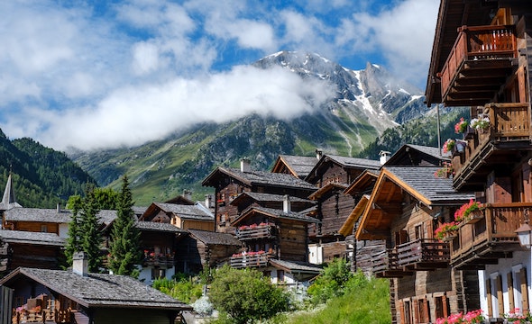 Swiss chalet surrounded by green mountaintops